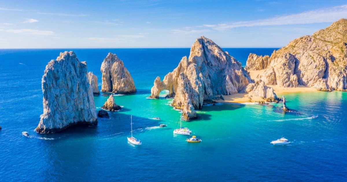 Expansive view of blue and green water around the Lands End and El Arco rock formations on the beach in Cabo San Lucas
